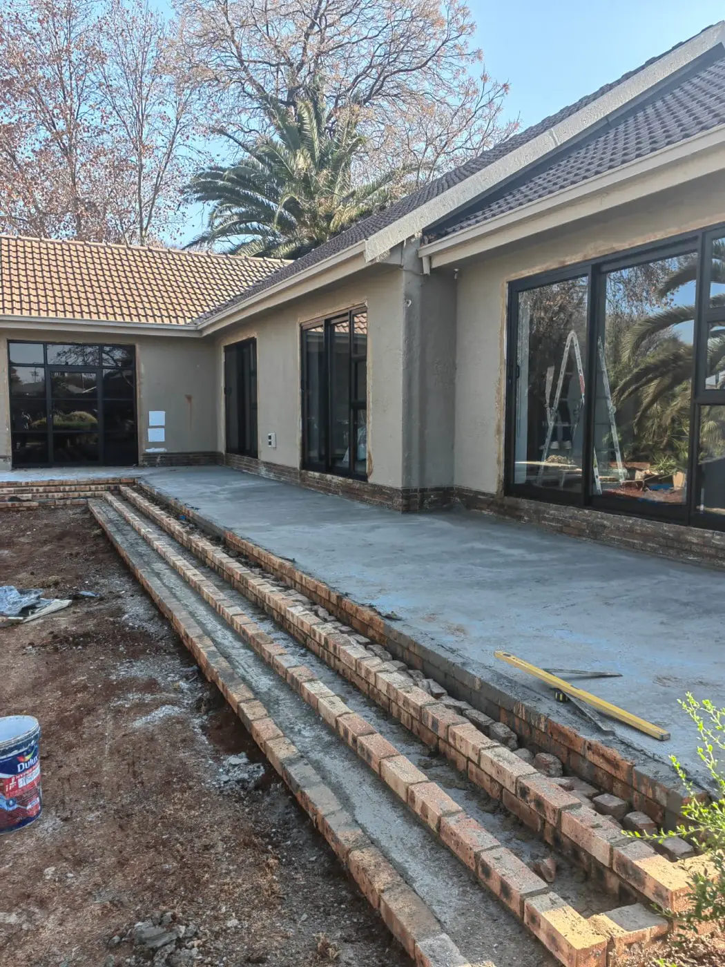 New brick steps being laid along the patio