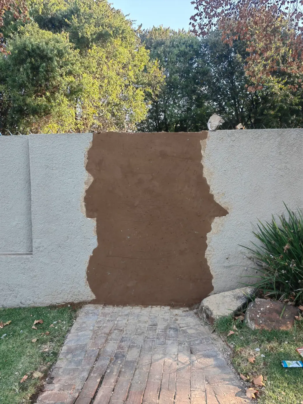 A plastered repair drying on the white wall